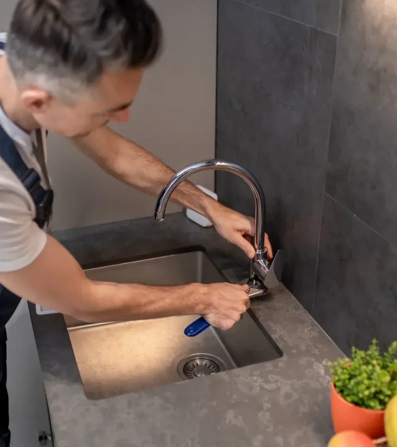 man-adjusting-water-tap-with-wrench-qdxu19lzpxi0dv3l5s14ma3l4qtdik4ovafjxlgox4